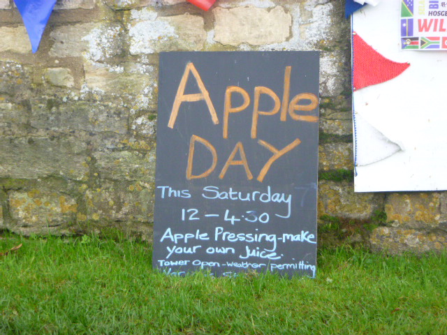 Apple Day event poster on a lawn