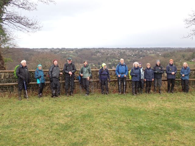 Group of hikers with countryside view.